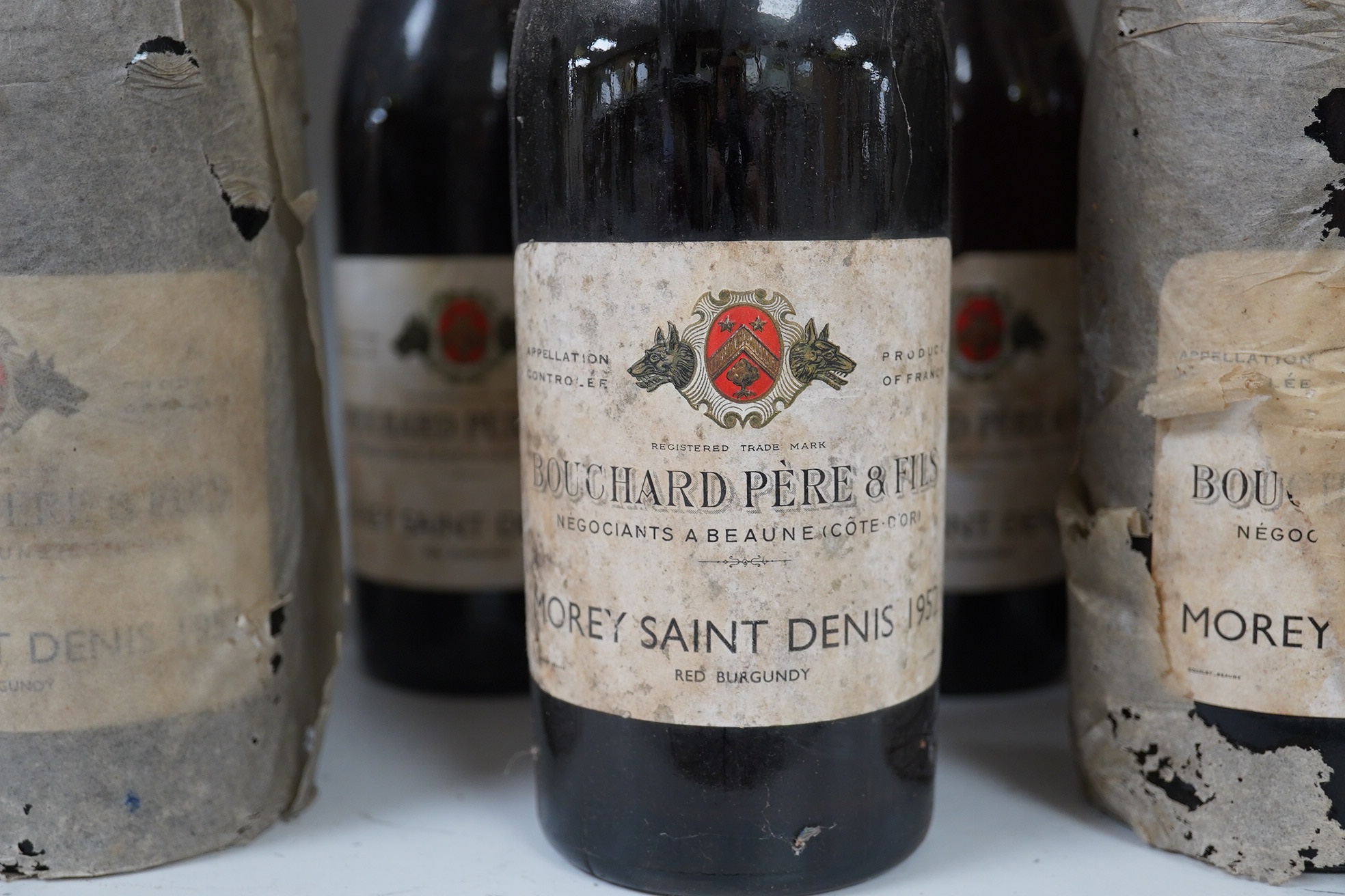 Twelve bottles of 1952 Bouchard Pere & Fils Morey Saint Denis red burgundy. Condition - fair to good, storage history unknown